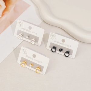 Three pairs of stainless steel earrings in gold, silver, and black with cz crystals