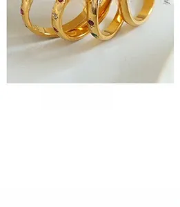 Detailed view of gold rings with colorful star-shaped gemstone accents and fine craftsmanship