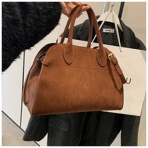 Close-up of brown suede tote bag with durable double handles and fine stitching details