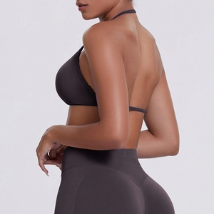 Detail of seamless ribbed halter sports bra and high-waist leggings in dark brown