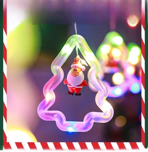 Detail of Christmas tree LED light hanging with a cute Santa Claus doll inside