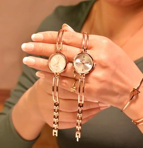 Close-up of rose gold minimalist bracelet watches on wrist with small round dials