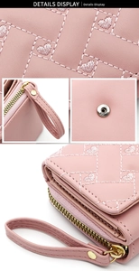 Detailed close-up of pink PU leather texture with heart embroidery and golden zipper