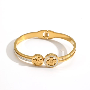 Elegant 18K gold plated clover bangle featuring sparkling diamonds and hollow floral design