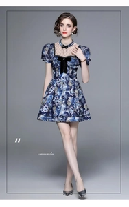Detail of blue floral A-line dress with puff sleeves and lace hollow collar