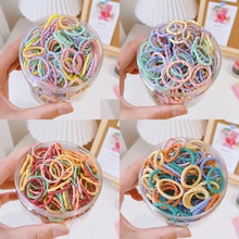 Macro detail of colorful elastic hair bands in a transparent jar for styling