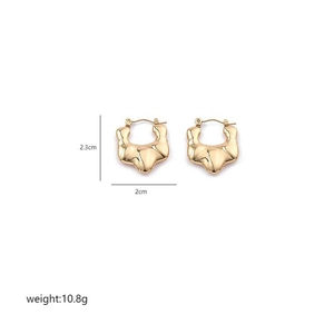 Detailed view of irregular gold hoop earrings with ridged texture and dimensions