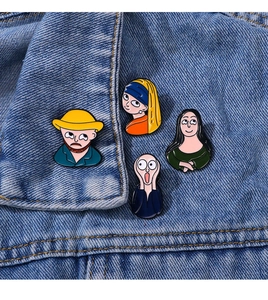Close-up of four artistic enamel pins inspired by famous paintings on a denim jacket collar