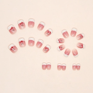 Pink gradient French press-on nails with cute cherry designs and glossy finish