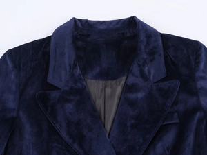 Detail of notch lapel on dark blue velvet blazer with smooth black lining texture