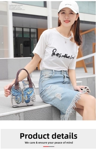 Close-up of ethnic woven handbag with yellow butterfly embroidery in outdoor setting