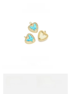 Detail view of 18K gold plated butterfly pendant featuring peacock blue opal heart inlay