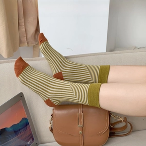 Striped cotton crew socks with green stripes and contrasting red toe and heel details