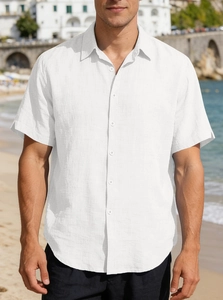 Close-up of white short-sleeved linen shirt featuring classic collar and textured fabric