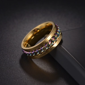 Detailed close-up of golden titanium spinner ring with colorful rainbow chain inlay