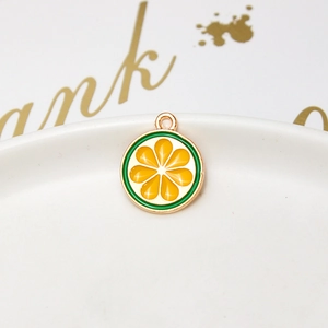 Detail of yellow lemon slice alloy pendant with gold plating for DIY jewelry making
