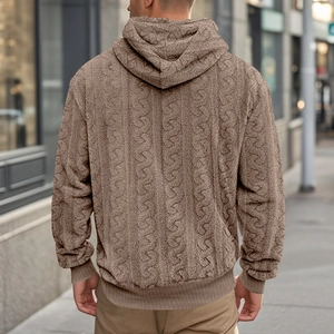 Detail of men's brown jacquard teddy fleece hoodie featuring textured 3D fabric and street style