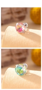 Macro detail of round gradient zircon stud earrings with claw setting in silver metal