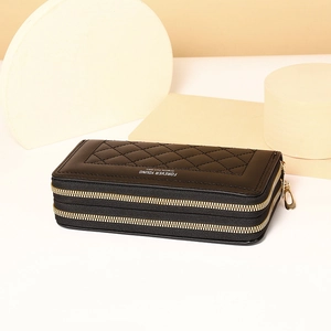 Detail of black double-zipper long wallet with diamond lattice stitching and metal logo