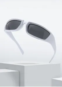 Detail view of white wrap-around sports sunglasses with dark lenses on a geometric stand