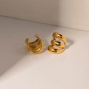 Pair of gold multi-layer spiral stainless steel ear cuffs with polished metallic finish