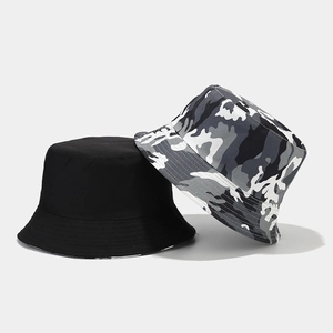 Detail of camouflage and black reversible bucket hats with reinforced brim stitching