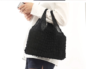 Detail of a black telescopic magic bag with stretch bubble pleat texture and soft fabric
