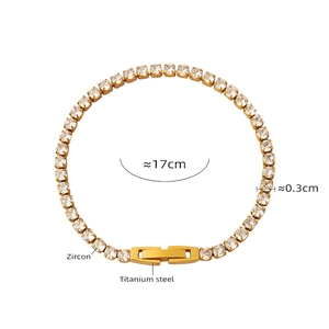 Detailed close-up of a gold titanium steel bracelet set with bright white zircon stones
