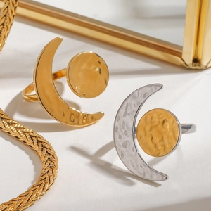 Detailed view of sun and moon rings featuring unique hammered texture and adjustable bands