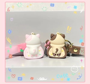 Close-up of cute cat butt keychains in pink and brown patterns with metal rings