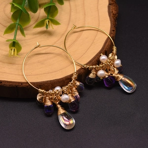 Elegant 925 silver earrings with freshwater pearls and purple tassels on wood