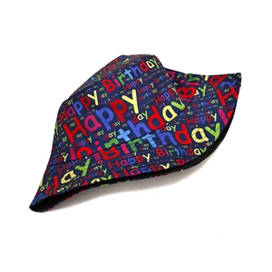 Close-up of Happy Birthday colorful print on deep blue cotton bucket hat fabric
