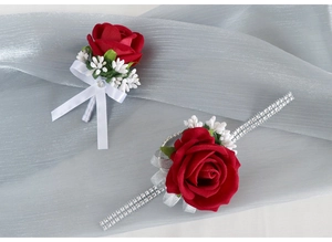 Close-up of red velvet rose boutonniere and wrist corsage with silver rhinestone band