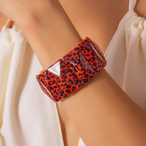 Detail of red and black leopard print acrylic link bracelet with high-gloss finish