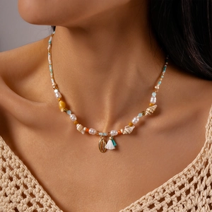 Detail of beach style choker with pearls, sea shell pendant and colorful beads