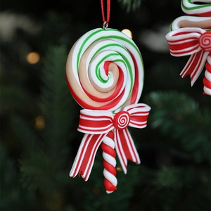 Christmas spiral lollipop ornament with red white green colors and a striped bow tie