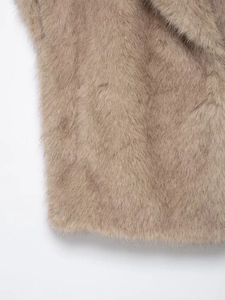 Detailed macro view showing soft faux fur texture and warm light brown plush fabric