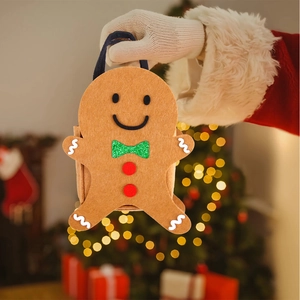 Detail of gingerbread man felt Christmas gift bag with green glitter bow and blue handle