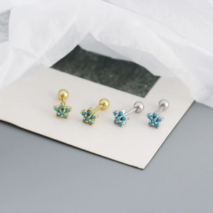 Macro shot of s925 silver flower stud earrings with turquoise zircon and screw ball back