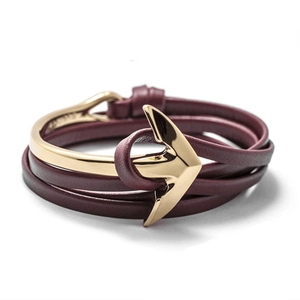 Macro view of burgundy leather wrap bracelet with a golden anchor hook clasp