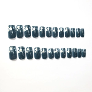 Deep teal press-on nails set with delicate white floral patterns and starry dots