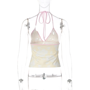 Detail view of floral halter top with pink trim and lace-up neck on a white background