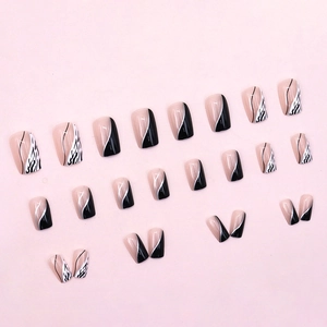 24-piece press-on nails set with black and white zebra patterns and gold curved lines