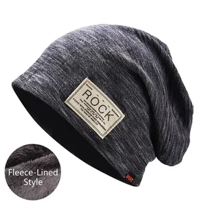 Close-up of dark grey slouchy beanie featuring a warm fleece lining and ROCK fabric patch