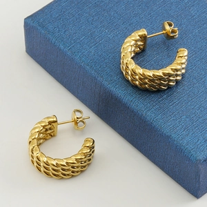 Polished 18k gold C-shaped twisted hoop earrings with textured weave design for women