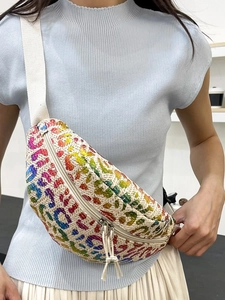 Straw waist bag with colorful leopard print and adjustable strap on female model