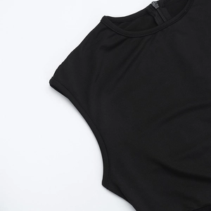 Detail shot of the round neckline and rear invisible zipper on a black mesh jumpsuit