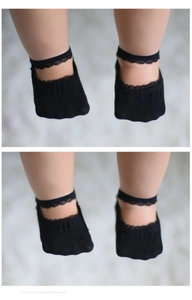 Detail of baby girls' black cotton lace boat socks with elegant lace strap design