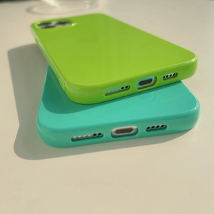Detail of neon green and cyan jelly cases showing precise charging ports for iPhone