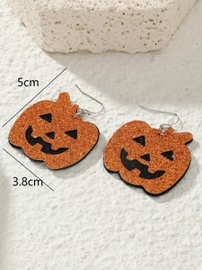 Detailed view of orange glitter pumpkin earrings with size dimensions 5cm x 3.8cm